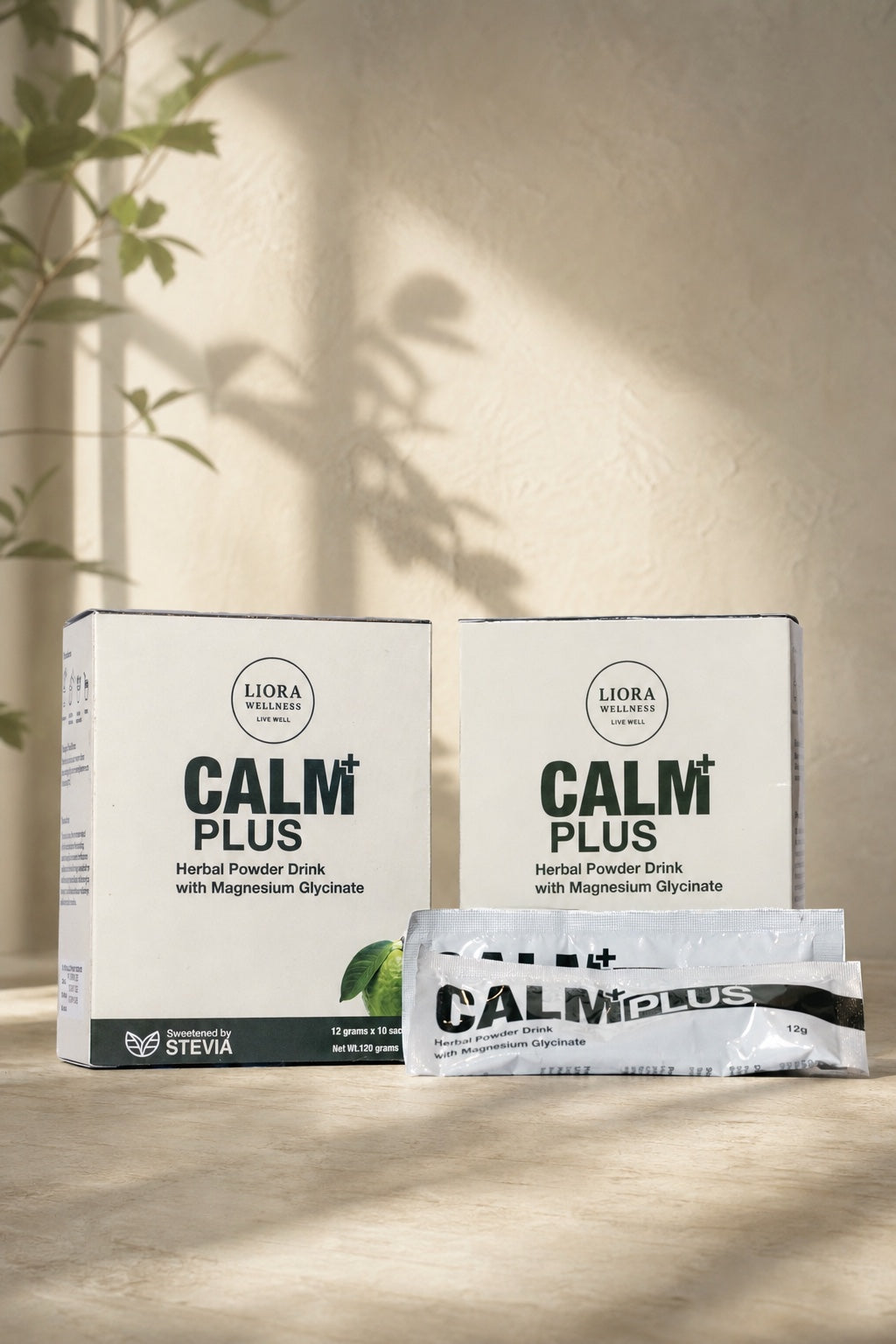 Two Calm Plus boxes and sachets in a warm, naturally lit wellness setting